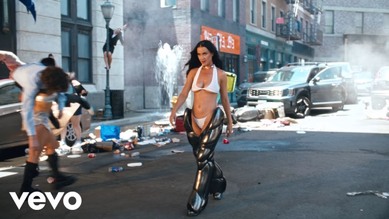 Katy Perry has officially opened the portal to her highly anticipated studio album "143" with the release of her vibrant and audacious new single, "Woman’s World." The extravagant music video, unveiled on Thursday, showcases Perry's fearless creativity and boldness, featuring scenes where she brandishes a hot pink vibrator, pretends to pee in a urinal, and even refuels herself with a gas nozzle. The video also includes a memorable cameo from Trisha Paytas, who drives a monster truck with Perry riding shotgun. "It's a woman's world, and you're lucky to be living in it," Perry sings, embodying the spirit of empowerment and celebration that defines the album. Dressed as both Rosie the Riveter and a bionic woman, Perry's performance is a striking visual representation of female strength and resilience. The single's release marks the first glimpse into "143," Perry's first album since 2020's "Smile," set to drop on September 20. In her statement about the album, Perry explained, "I set out to create a bold, exuberant, celebratory dance-pop album with the symbolic 143 numerical expression of love as a throughline message." This sentiment is perfectly captured in the cinematic video, which features Perry and a crew of dancers waving around props symbolic of "living in a woman’s world," including women's vitamins and wellness tools. The album "143," which translates to "I love you" in pager code from the early 1990s, promises a nostalgic yet forward-looking experience. Perry's collaboration with producers like Dr. Luke, Stargate, Max Martin, and Sarah Hudson ensures a rich, high-energy soundscape that fans can eagerly anticipate. Despite the controversy surrounding Dr. Luke's involvement due to past allegations against him, Perry's commitment to a message of female empowerment remains strong. Perry's return to music comes after wrapping up her Play residency in Las Vegas and a seven-season stint as a judge on "American Idol." With "Woman’s World," she not only reclaims her place in the pop music world but also sets a powerful tone for what promises to be an era of celebration, love, and unyielding female empowerment. As Perry continues to tease more content from "143," fans can look forward to an album that is as dynamic and exuberant as the artist herself. Get ready to embrace "143" on September 20, and in the meantime, dive into the electrifying world of "Woman’s World."