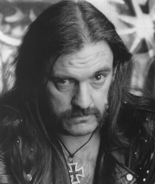 Lemmy Kilmister performing live with Motörhead, embodying rock 'n' roll spirit