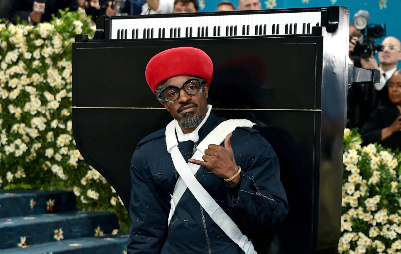 André 3000 performing with piano on his back at Met Gala
