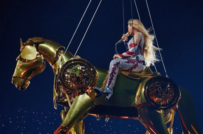 Beyoncé performing on a golden horse during Cowboy Carter Tour in Atlanta