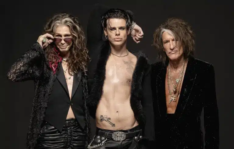 Aerosmith and Yungblud Collaborate. Alt Text: Iconic rock band Aerosmith performing on stage with British rocker Yungblud.