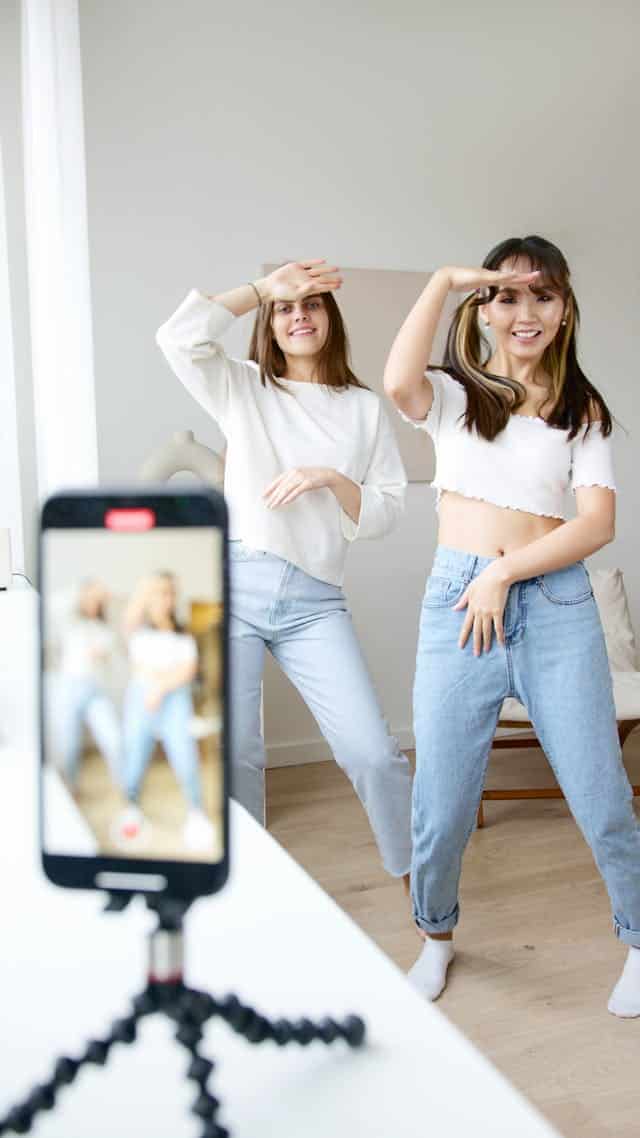 Young woman dancing while recording a TikTok video
