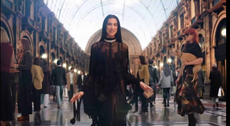 Dua Lipa walking through Milan’s Galleria in NBC’s Winter Olympics promo