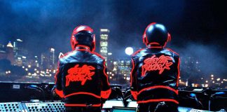 Daft Punk on stage wearing helmets, representing their Discovery legacy