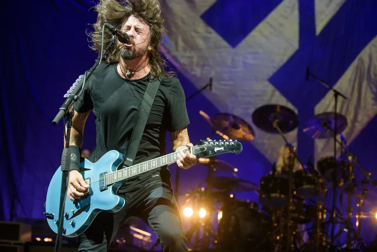 Foo Fighters frontman Dave Grohl performing live, representing the raw energy of the new single Caught in the Echo