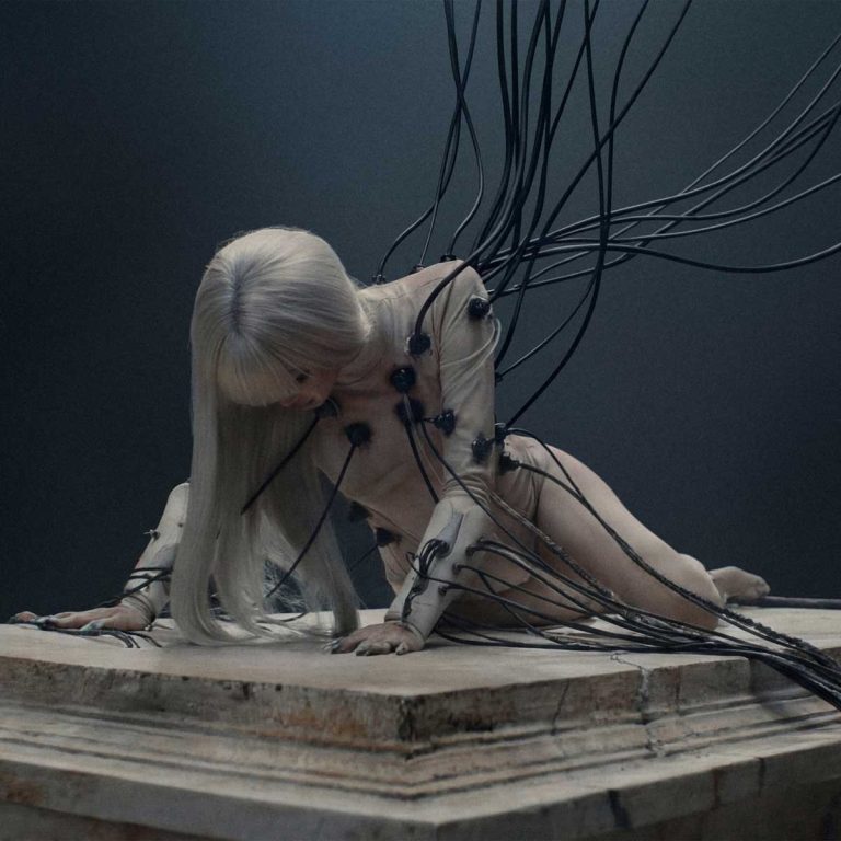 LISA from BLACKPINK with cybernetic bionic wings in Anyma's Bad Angel music video.