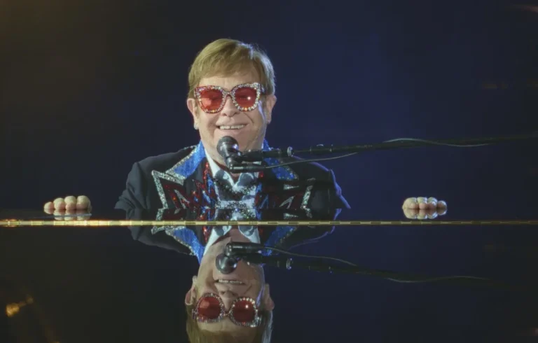 Elton John performing at the piano