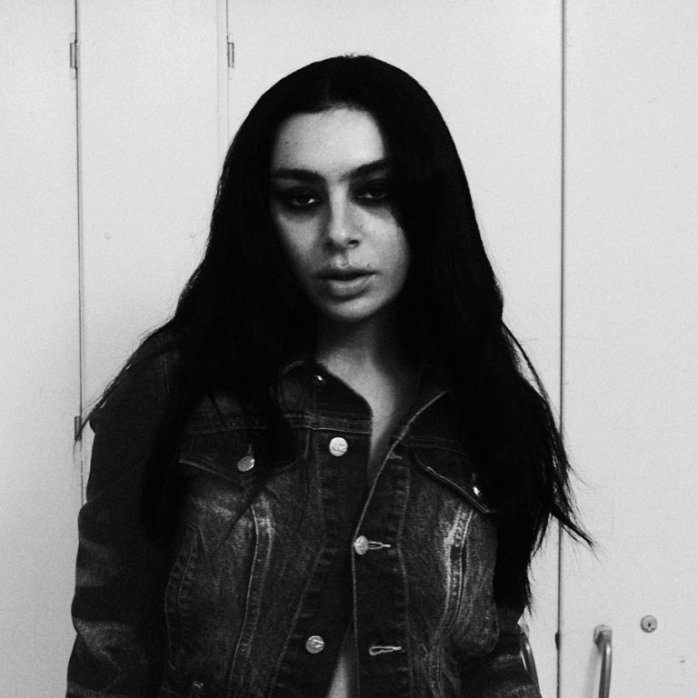 Charli xcx transitioning from her Brat era to her rock music phase, incorporating prominent guitar and experimental electro-pop elements.